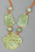 A Chinese jade necklace The carved and pierced vase shaped pendant flanked by fruit form spacers and
