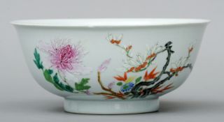 An 18th century Chinese famille rose bowl Decorated to the outside with flowering trees, the base