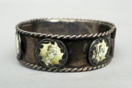 An Art Nouveau 800 Continental silver bracelet The ropetwist bordered band set with six enamelled