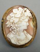 A Victorian unmarked yellow metal framed cameo brooch The front carved with a young lady with