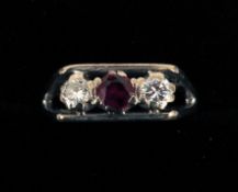 An 18 ct white gold three stone ruby and diamond ring The central ruby flanked by two diamonds.