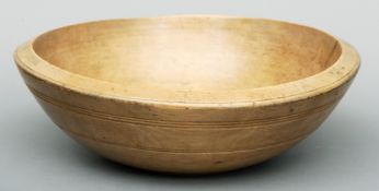 A late 18th/early century turned sycamore bowl With ring turned decoration. 42 cms diameter.