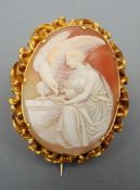 A Victorian unmarked yellow metal framed cameo brooch The scrolling framework enclosing the carved
