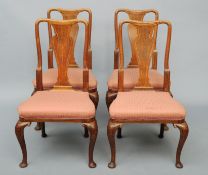 A set of four 19th century Queen Anne style oak dining chairs The crossbanded vase shaped central