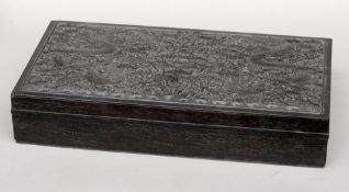 A Chinese carved ebony box The removable lid profusely carved with dragons chasing a flaming pearl