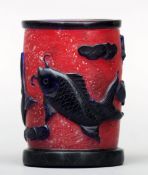 A Chinese cameo glass brush pot Of cylindrical form, the red ground decorated with fish amongst