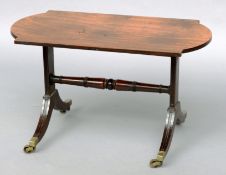 A small mahogany coffee table The shaped rectangular top above a trestle base with a turned