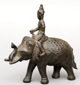 An Oriental patinated bronze model of an elephant Naturalistically modelled with a rider. 18 cms