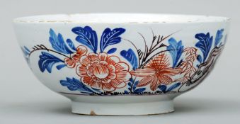 An 18th century polychrome Delft bowl With floral decoration to the exterior, in blue, iron red