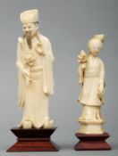 A carved ivory figure of a priest Modelled in flowing robes and holding a flower, mounted on a