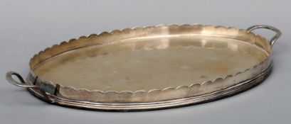 A 19th/20th century silver plated twin handled tray Oval, with shaped gallery. 61.5 cms wide