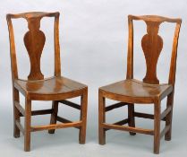 A set of four 18th century elm country chairs Each serpentine top rail above a vase shaped central