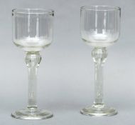 A pair of 19th century oversized wine glasses Each with bucket bowl, supported on an inverted