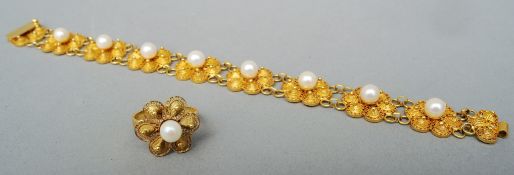 A pearl set 18 ct gold filigree bracelet Each link of flowerhead form; together with a matching
