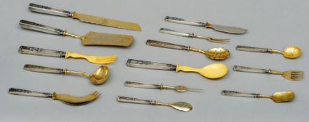 A quantity of Russian gilt and white metal flatware Each piece with swan and fern moulded handle. (