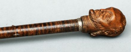 A Victorian walking stick The handle formed as the bust of a gentleman. 92 cms long.Some general