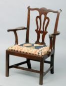 A 19th century mahogany open armchair The serpentine top rail above a pierced vase shaped back