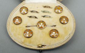 A cased set of unmarked white metal mounted shirt studs Each with a centrally set diamond, the