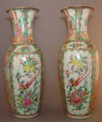 A pair of Chinese Canton porcelain vases Each typically decorated with figural and floral vignettes.