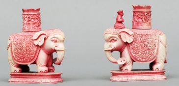 A pair of carved and stained ivory chess pieces Each formed as a turret above and elephant to