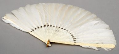 A late 19th/early 20th century Chinese Canton ivory feather fan The guards extensively carved with