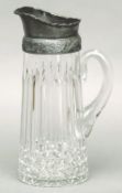 A pewter mounted glass jug The spreading body fluted. 29 cms high.Generally in good condition,
