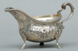 A George III silver sauce boat, hallmarked London 1819, maker’s mark indistinct Of typical form with