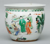 A large Chinese famille verte jardiniere Decorated with figures in various pursuits. 30 cms