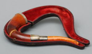 A 19th century Meerschaum pipe The white metal mounted horn shaped pipe fitted in a plush lined