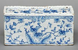 An 18th century Delft blue and white flower brick Of typical form pierced with twenty-seven holes