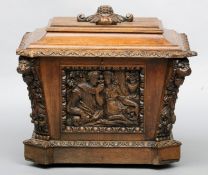 A Victorian carved oak cellaret Of sarcophagus form, carved to the front with a pair of lovers