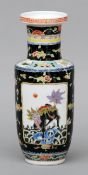 A 19th century Chinese famille noir rouleau vase and a Canton porcelain round box and cover The