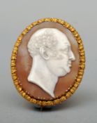 An 19th century unmarked yellow metal framed cameo brooch The front carved with a gentleman’s