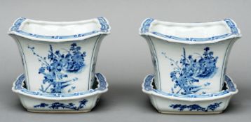 A pair of Chinese blue and white jardinieres on stands Decorated with landscape scenes and birds