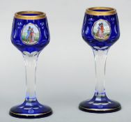 A pair of 19th century intaglio cut cameo wine glasses Blue overlaid with gilt highlights, each with