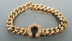 A Victorian 15 ct gold curb link bracelet Centrally set with a diamond and cabochon coral set