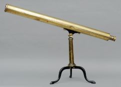 A 19th century brass telescope Mounted on a folding tubular brass stand with hinged cast iron