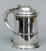 A George III silver lidded tankard, hallmarked London 1806, maker’s mark of RG The domed hinged