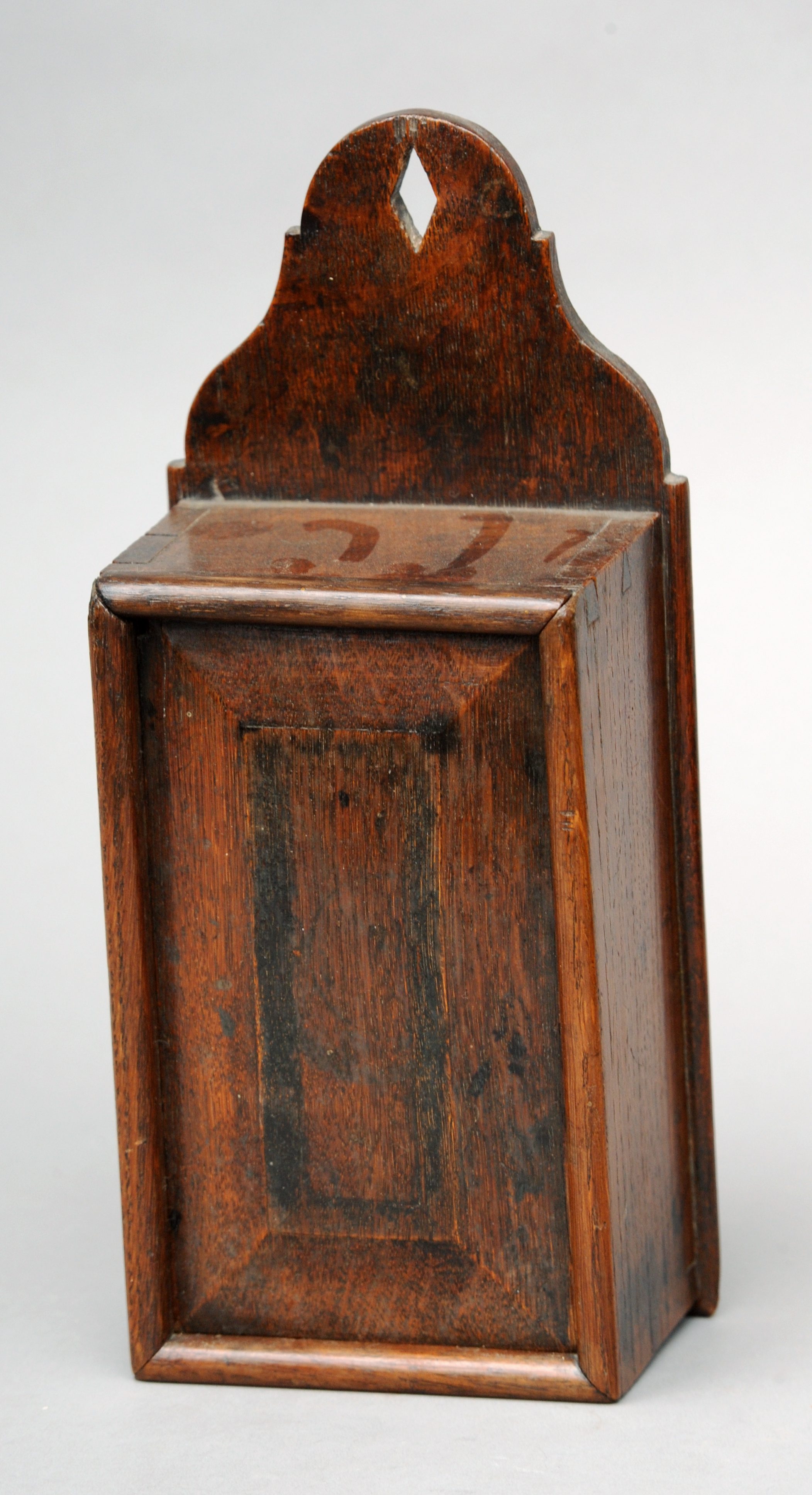 A 19th century oak candle/tinder box Of typical form with panelled rising front. 30 cms high