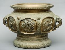 A large Chinese 19th century bronze twin handled jardiniere Decorated in high relief with birds in