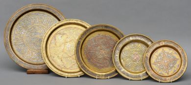 Five 19th century Cairo ware mixed metal circular trays Each with ornate decoration. The largest