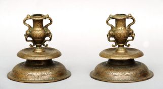 A pair of 19th century engraved brass Paduan style bronze candlesticks Each 15 cms high. (2)