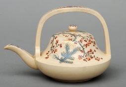 A late 19th/early 20th century Japanese Satsuma pottery teapot Decorated with flowering boughs and