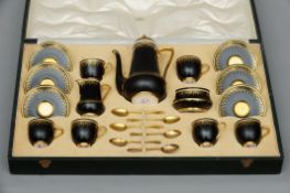 An early 20th century cased Royal Worcester six piece coffee set The black bodies with gilt
