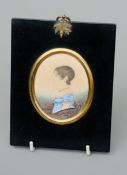 An early 19th century portrait miniature of a young girl Watercolour, in ebonised frame. 11 cms