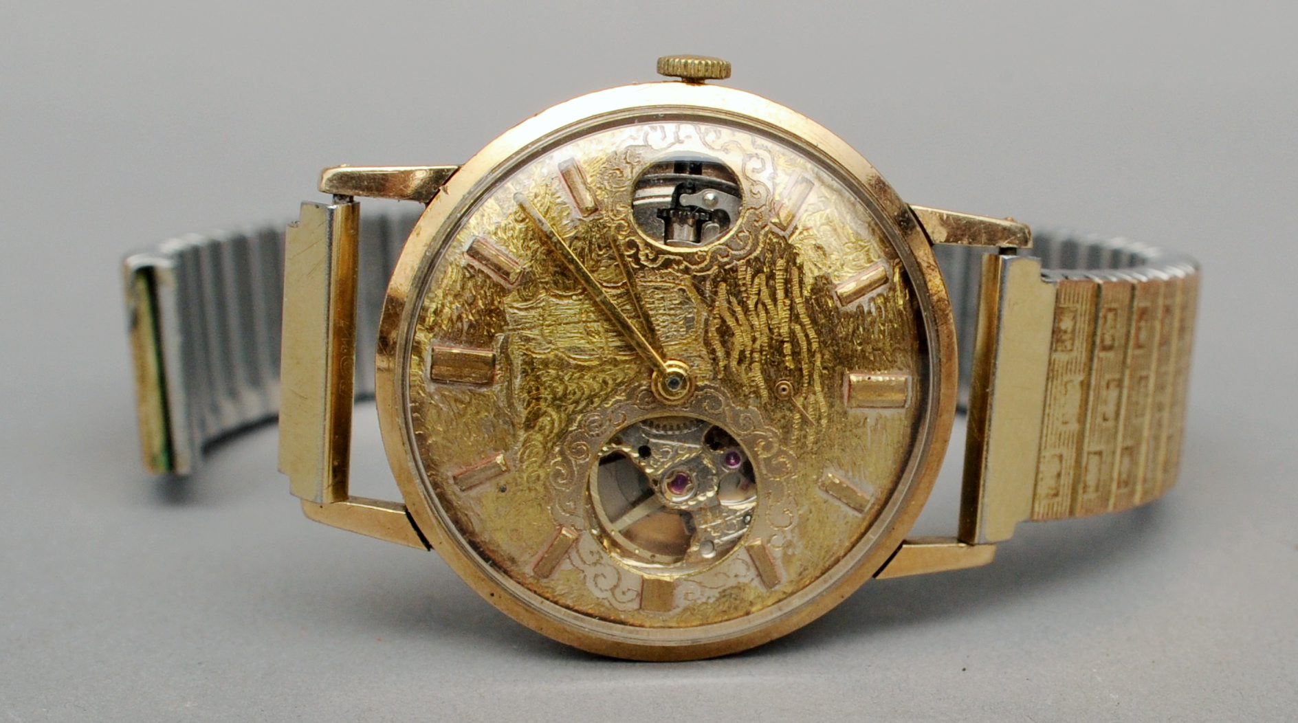 A 9 ct gold cased gentleman’s wristwatch The chased dial decorated with a marine scene and with