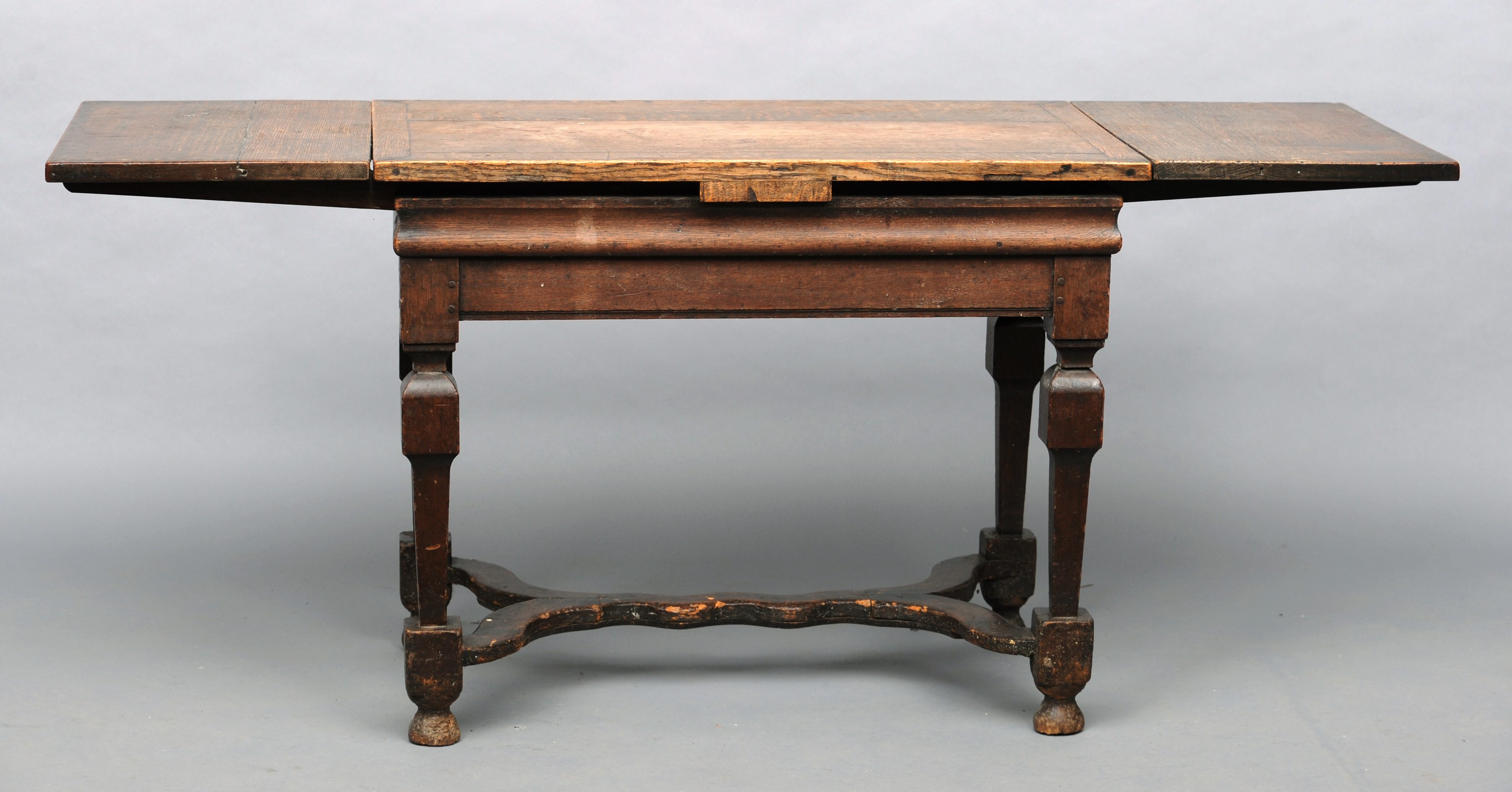 An 18th century and later oak draw leaf table The cleated rectangular top above two draw leaves over