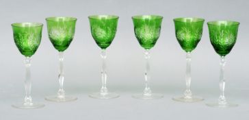 A set of six Stevens & Williams intaglio cut cameo wine glasses Green overlaid, supported on knopped