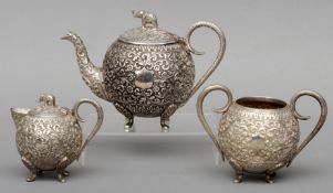 An Indian white metal three piece tea set Comprising: lidded teapot, sucrier and lidded cream jug,
