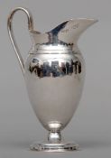 An Edward VII silver cream jug, hallmarked London 1901, maker’s mark of Elkington & Co., Limited